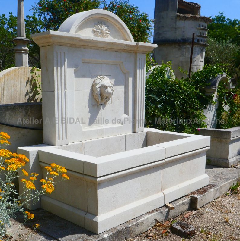 Garden fountain in stone with sculptures and lion's head | Atelier Alain BIDAL - Provence.