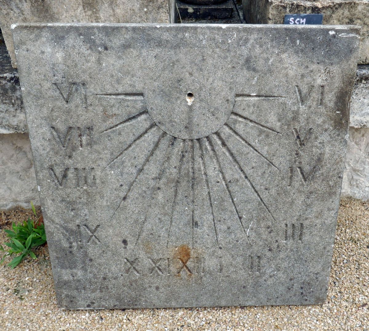 Large sundial in patinated limestone hand-sculpted with Roman numbers