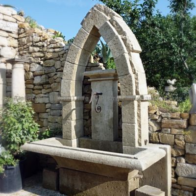 Gothic-style garden wall fountain carved by Alain Bidal in Provence.