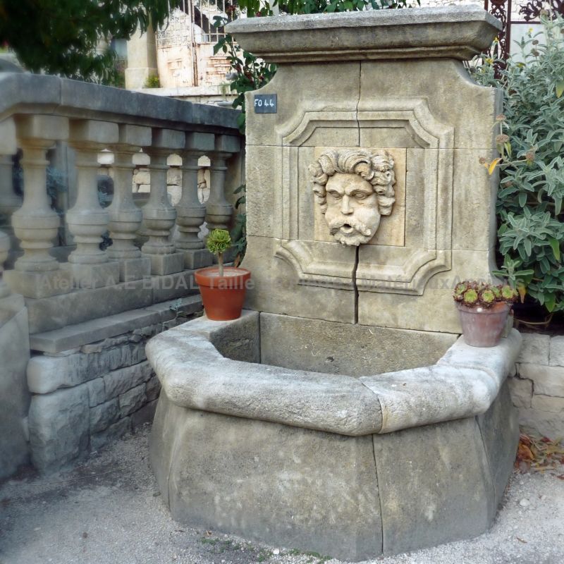 Rustic fountain with a stone sculpture representing Aeolus, the Greek God King of the Winds - Atelier Alain BIDAL (Provence)