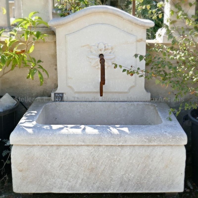 Decorative garden fountain with massive trough and hand-sculpted pediment carved by the artisan stonemason Alain BIDAL.