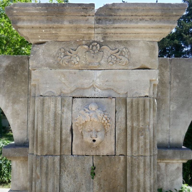 Pediment very finely hand-carved from our natural limestone wall fountain on sale at Alain Bidal in Provence.