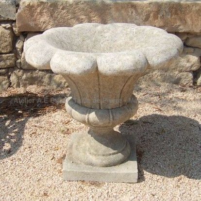 Natural limestone vase carved in athe shape of a flower