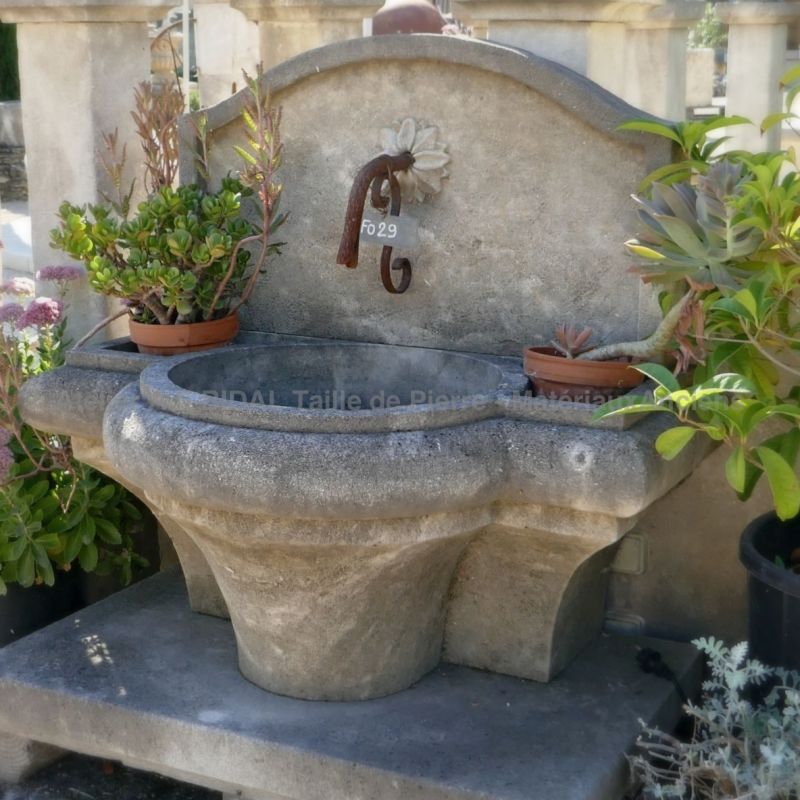 Fontaine de jardin rustique en pierre naturelle taillée par notre tailleur de pierre de l'atelier Bidal du Vaucluse.
