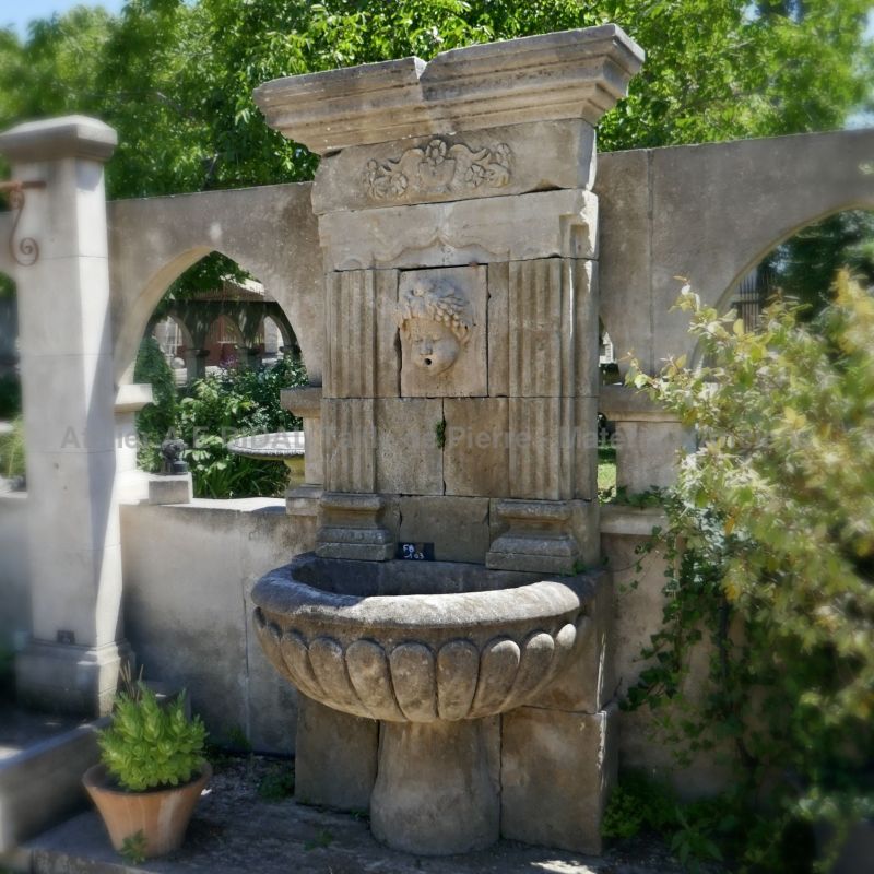 Antique garden fountain in French limestone - decorative fountain of Provence.